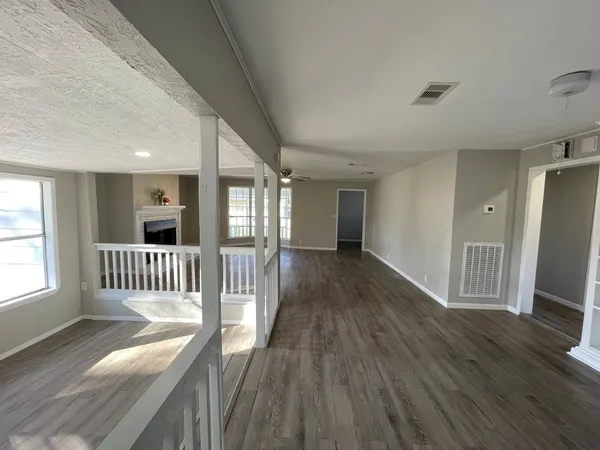 a view of a room with wooden floor and fence