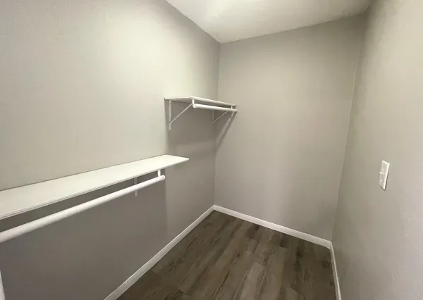 a view of a room with wooden floor
