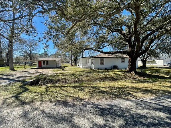 a house that has a tree in front of it