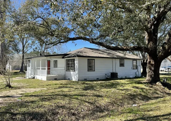 a house that has a tree in front of it