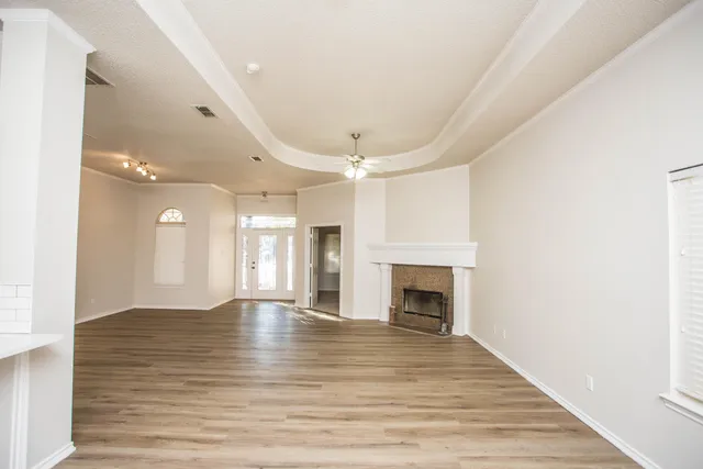 a view of a room with wooden floor and bathroom