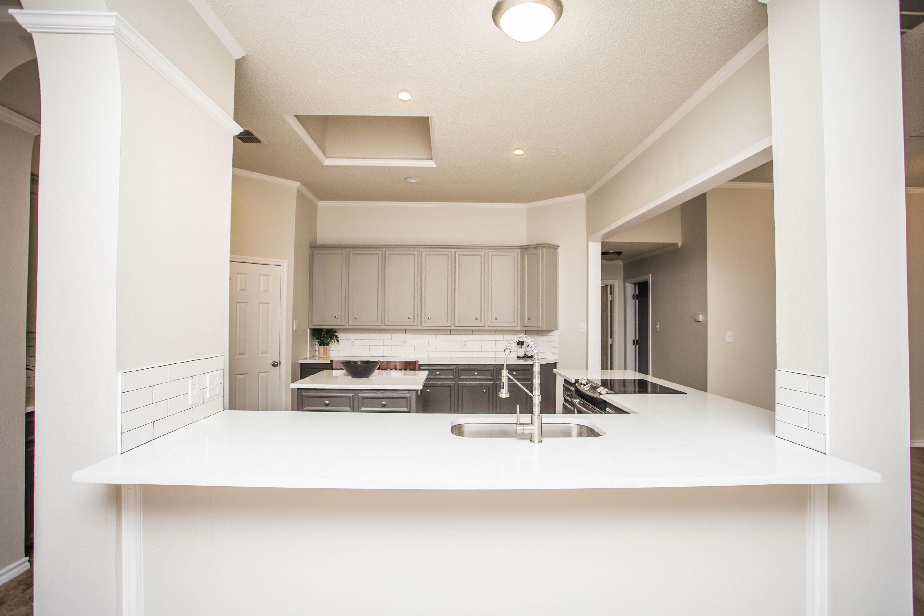 616 North 8th Street Wolfforth, TX 79382 - Photo 16 of 50 a kitchen with kitchen island a sink stainless steel appliances and cabinets