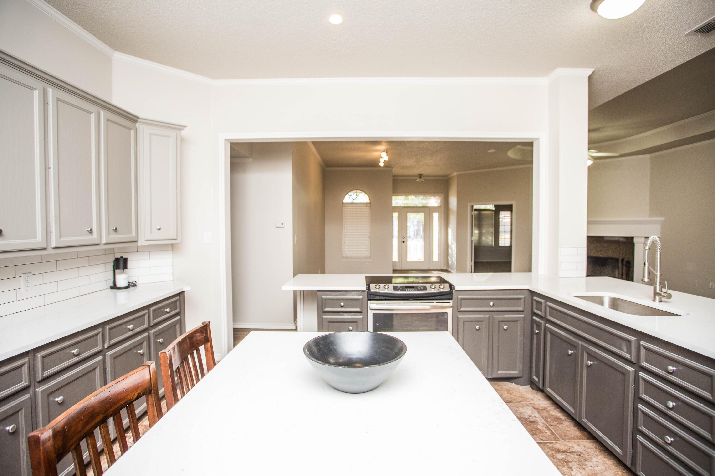 616 North 8th Street Wolfforth, TX 79382 - Photo 18 of 50 a large kitchen with kitchen island a sink stainless steel appliances and cabinets