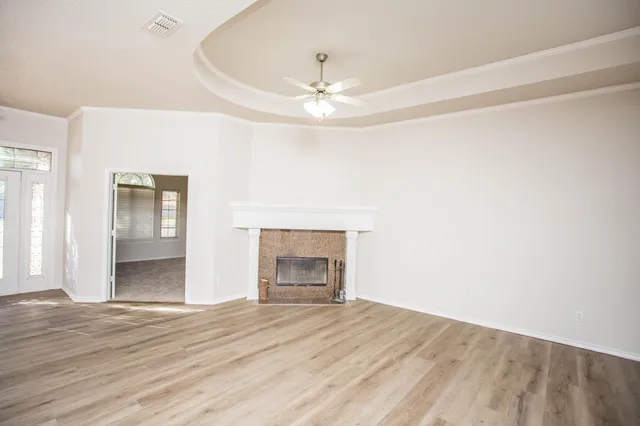a view of a room with wooden floor