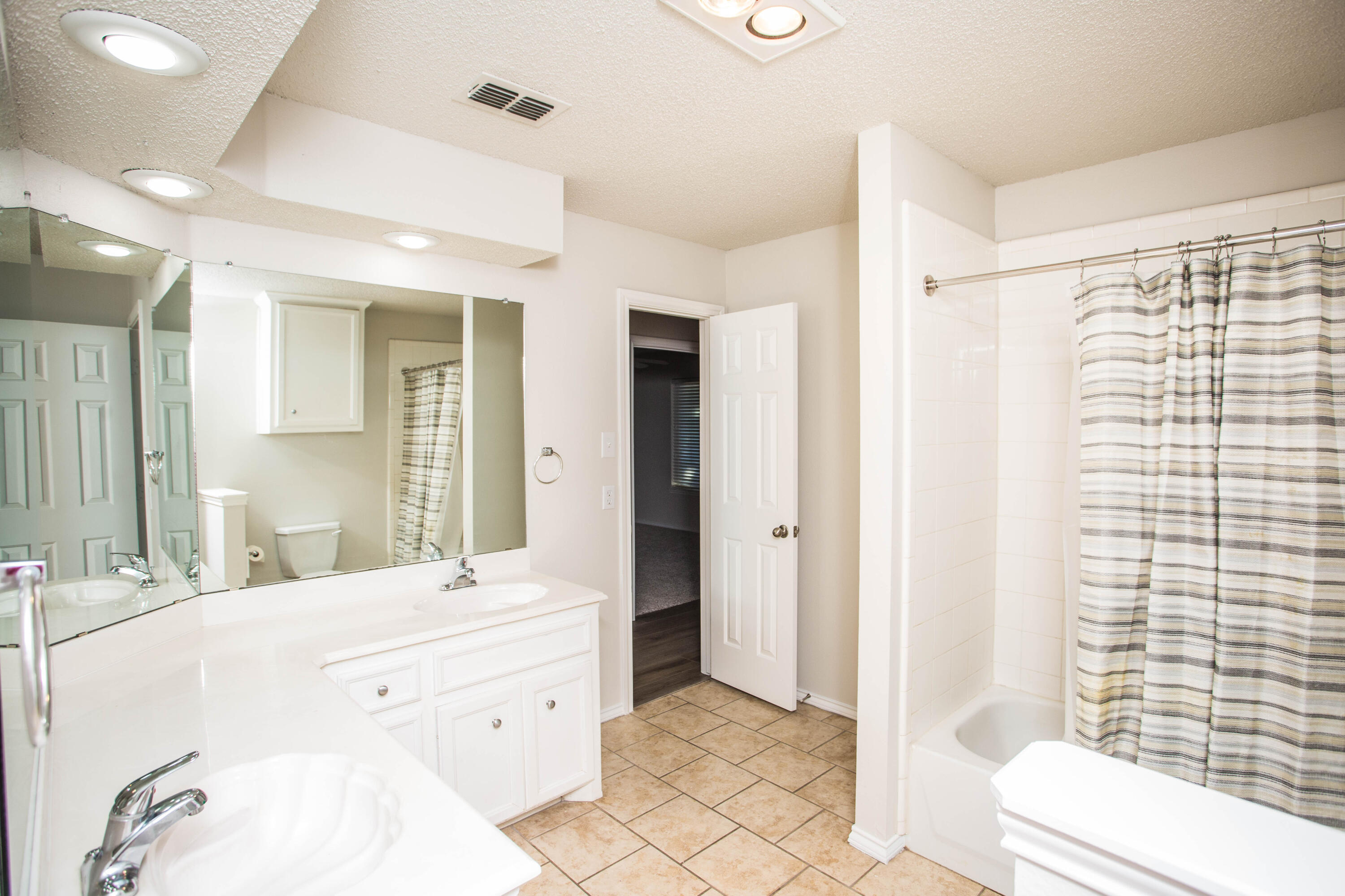 616 North 8th Street Wolfforth, TX 79382 - Photo 25 of 50 a spacious bathroom with a double vanity sink toilet and shower