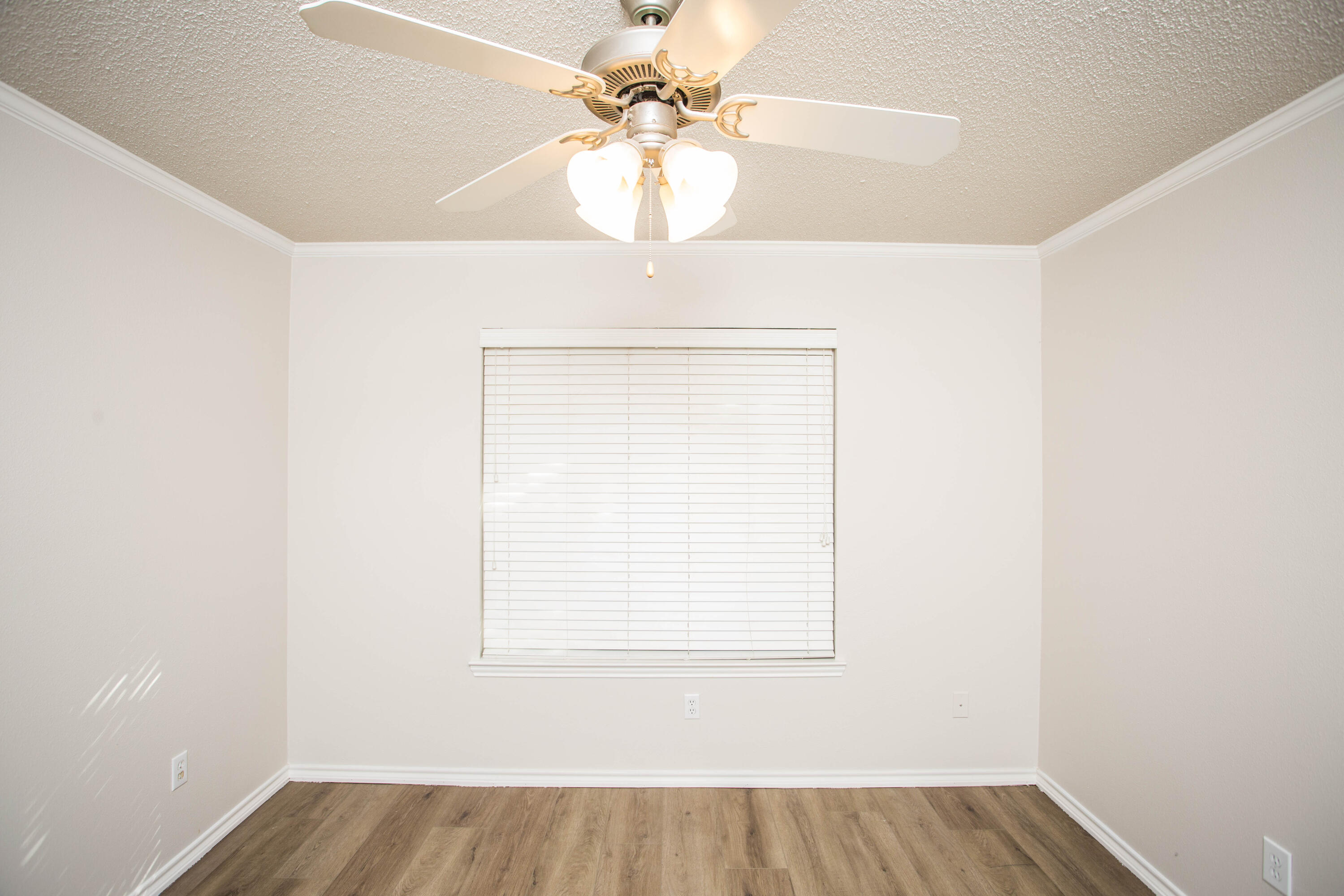 616 North 8th Street Wolfforth, TX 79382 - Photo 30 of 50 an empty room with a window and a chandelier fan