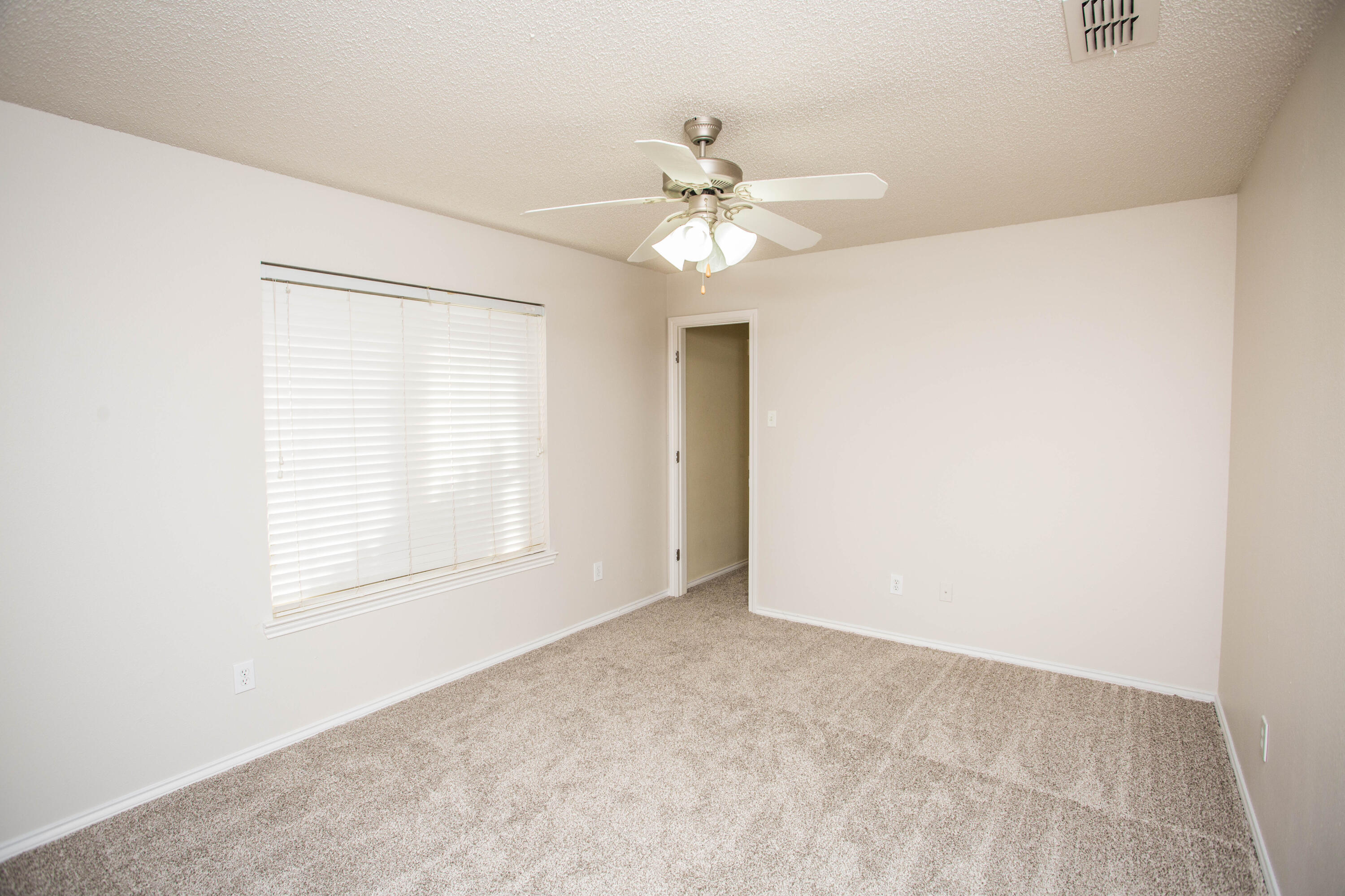 616 North 8th Street Wolfforth, TX 79382 - Photo 34 of 50 an empty room with a window and a fan