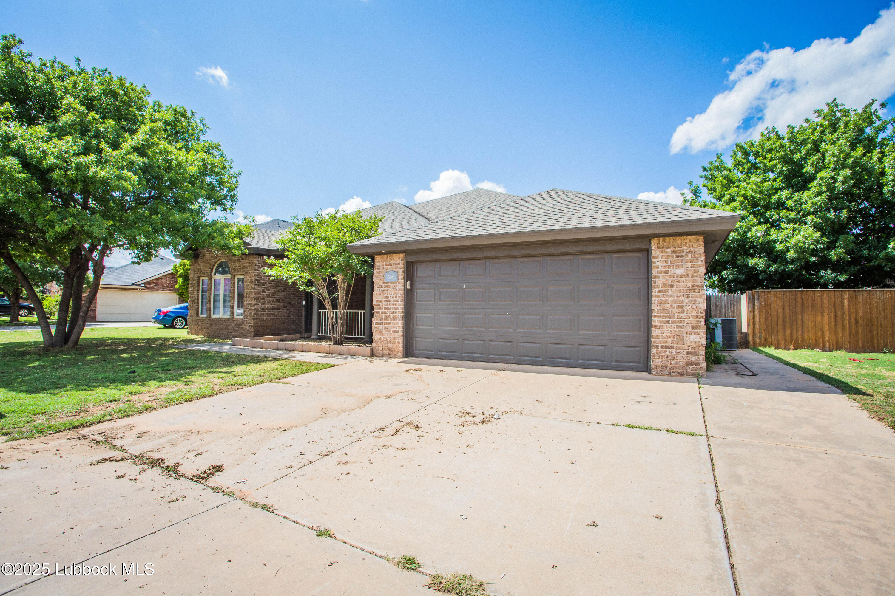 616 North 8th Street Wolfforth, TX 79382 - Photo 4 of 50 a front view of a house with a yard and a garage