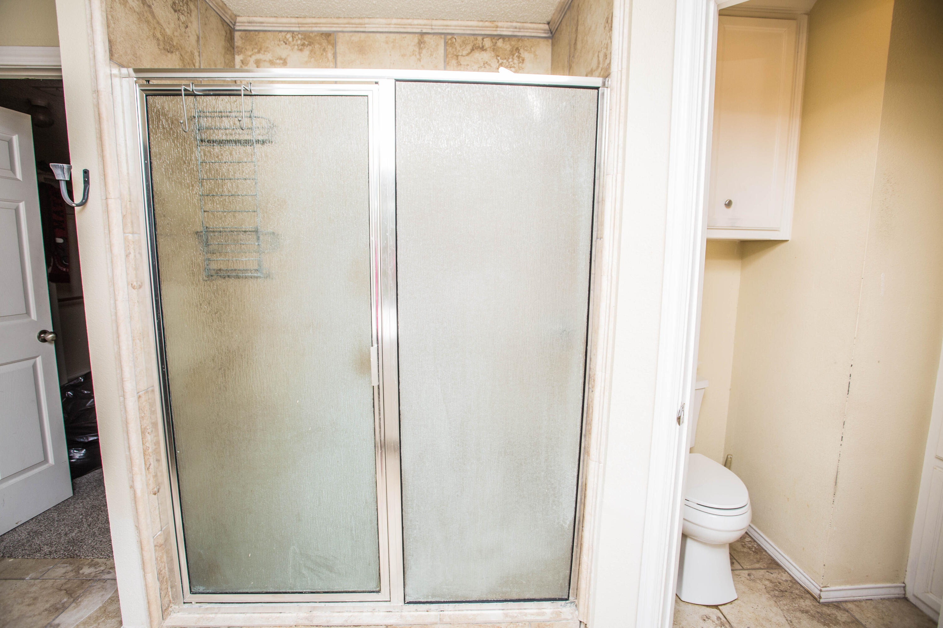 616 North 8th Street Wolfforth, TX 79382 - Photo 42 of 50 a bathroom with a granite countertop shower and a toilet