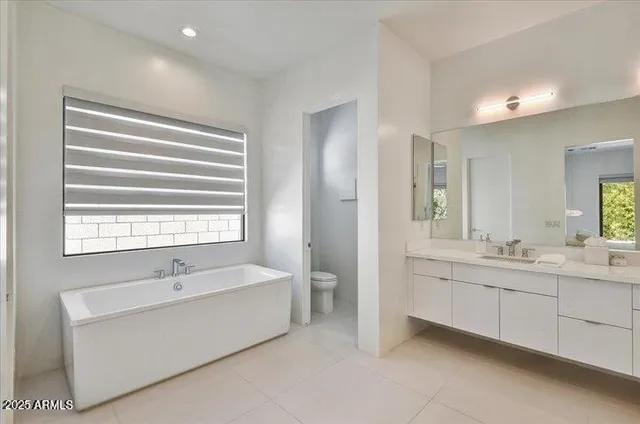 a bathroom with a double vanity sink mirror and shower