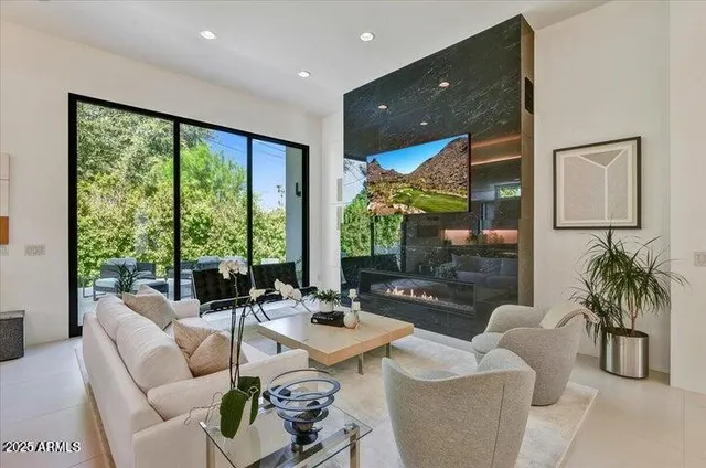 a living room with furniture and a floor to ceiling window