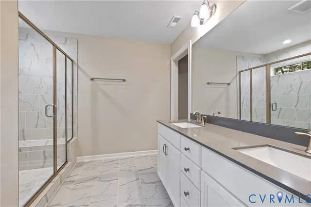 a spacious bathroom with a granite countertop sink mirror and double