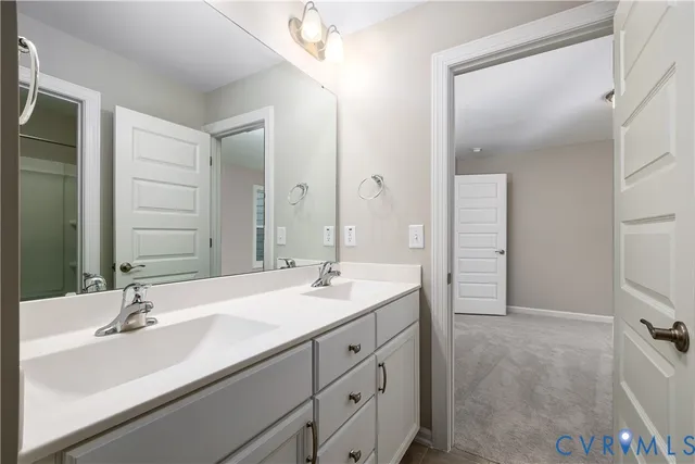 a bathroom with a sink double vanity and a mirror