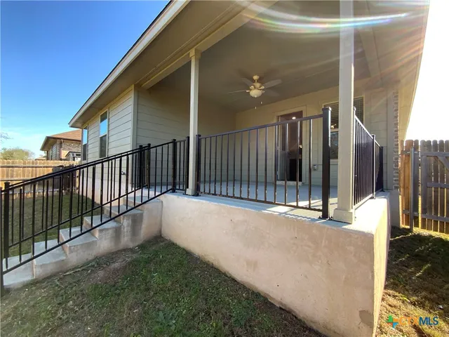 a view of balcony with floor to ceiling window and wooden fence