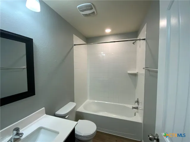 a bathroom with a bathtub a toilet a sink and a shower
