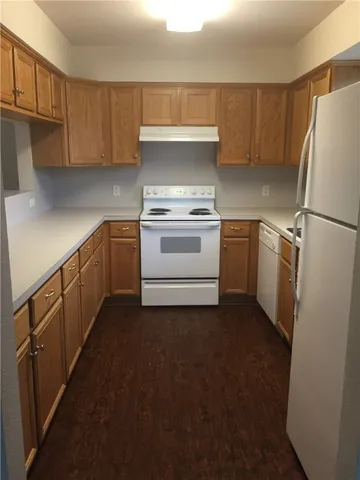a kitchen with a stove refrigerator and cabinets