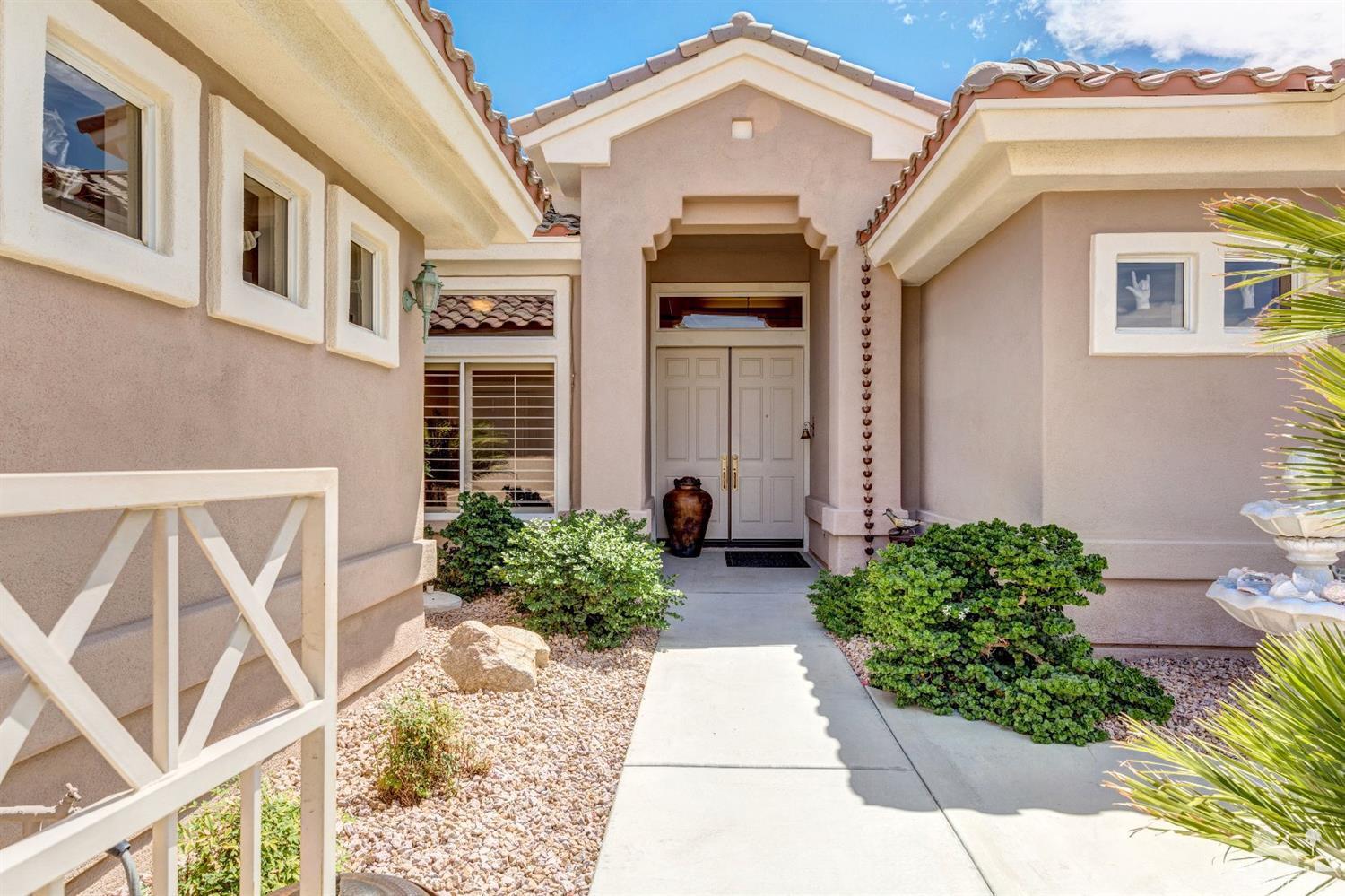 78087 Hunter Point Road Palm Desert, CA 92211 - Photo 2 of 37 a front view of a house with a yard