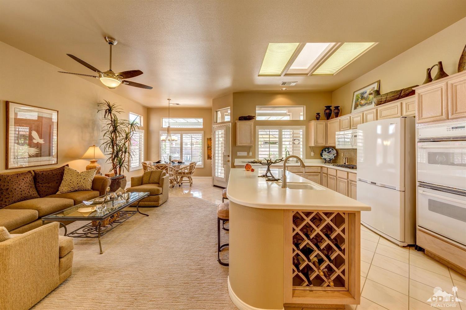 78087 Hunter Point Road Palm Desert, CA 92211 - Photo 11 of 37 a very nice looking living room with a large window and chandelier