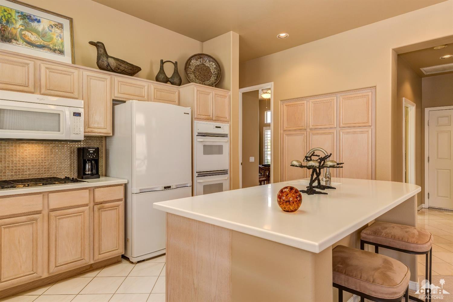 78087 Hunter Point Road Palm Desert, CA 92211 - Photo 14 of 37 a kitchen with granite countertop a sink cabinets and stainless steel appliances