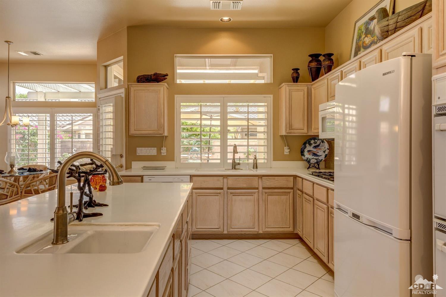 78087 Hunter Point Road Palm Desert, CA 92211 - Photo 15 of 37 a kitchen with a sink and appliances