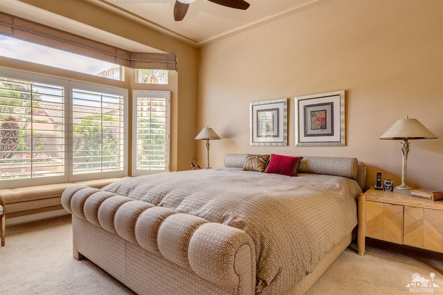 78087 Hunter Point Road Palm Desert, CA 92211 - Photo 17 of 37 a bedroom with a large bed and a couch