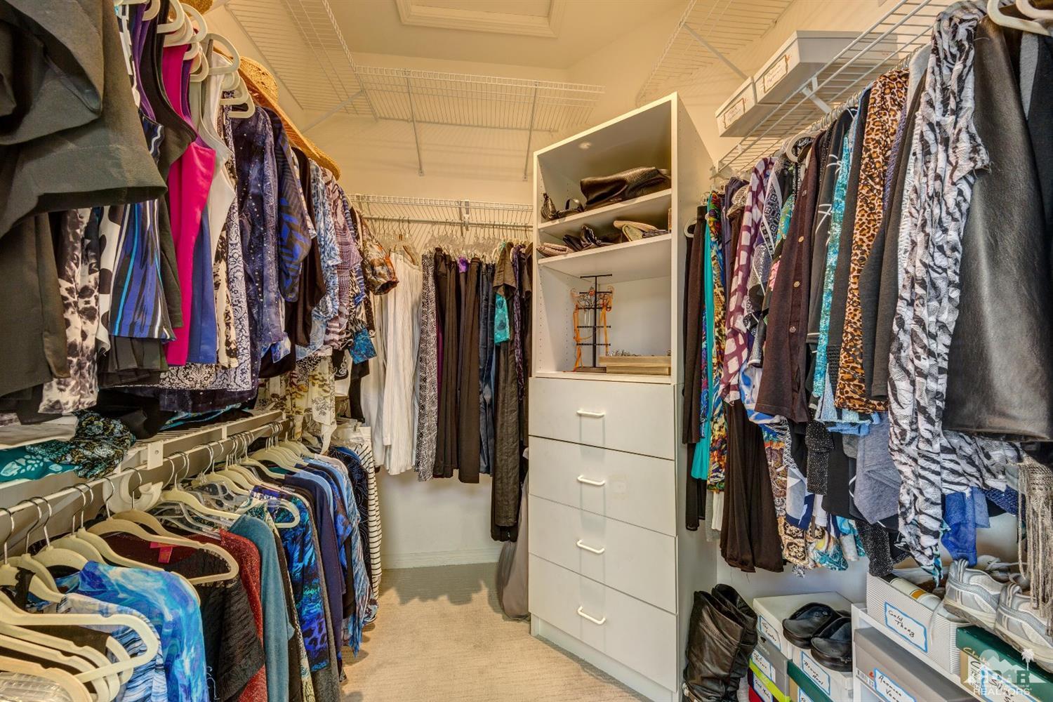 78087 Hunter Point Road Palm Desert, CA 92211 - Photo 22 of 37 a view of walk in closet with clothes and shoes