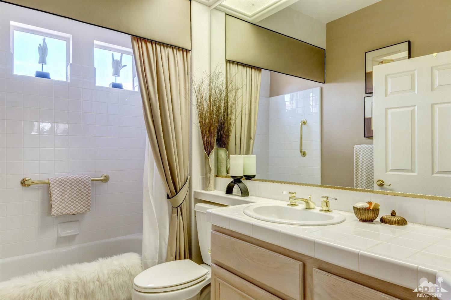 78087 Hunter Point Road Palm Desert, CA 92211 - Photo 25 of 37 a bathroom with a granite countertop sink toilet and shower