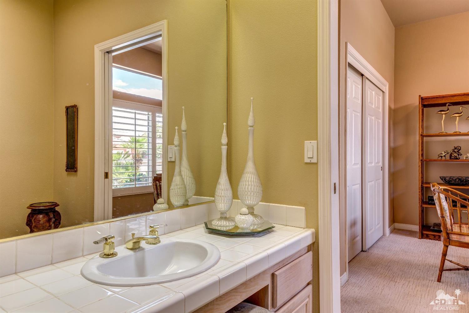 78087 Hunter Point Road Palm Desert, CA 92211 - Photo 27 of 37 a bathroom with a sink and a mirror