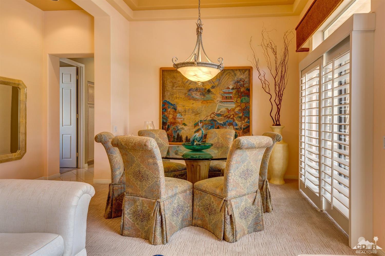 78087 Hunter Point Road Palm Desert, CA 92211 - Photo 9 of 37 a dining room with furniture and chandelier