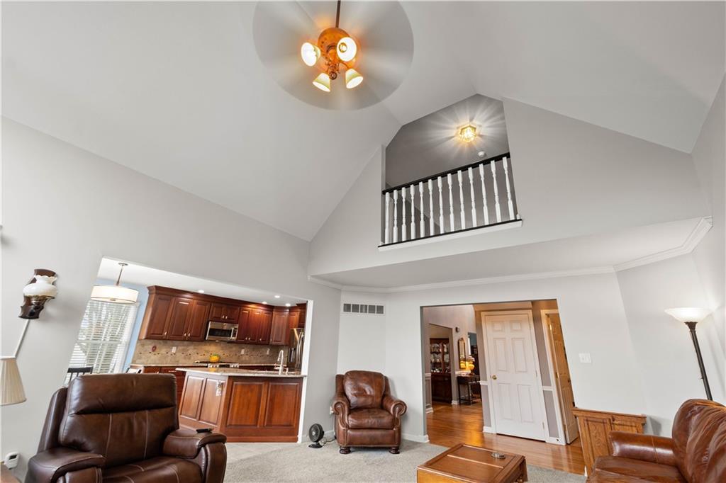 110 Walnut Drive Eighty Four, PA 15330 - Photo 12 of 50 a living room with furniture a flat screen tv and kitchen view