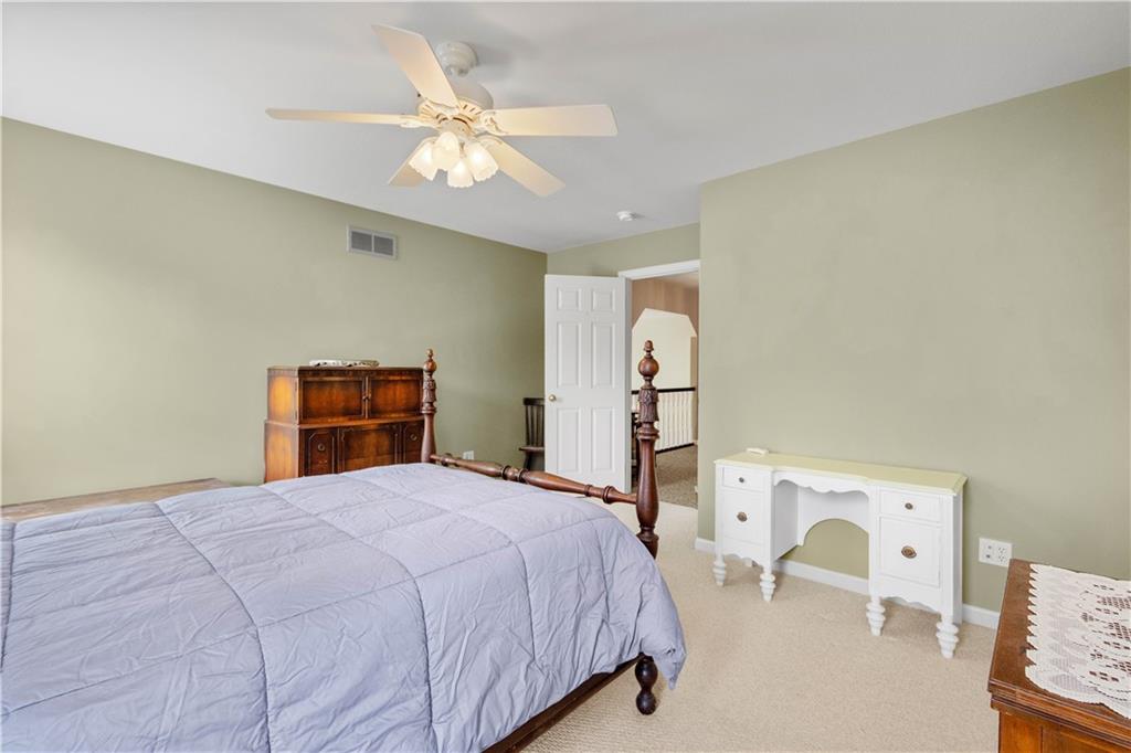 110 Walnut Drive Eighty Four, PA 15330 - Photo 33 of 50 a bedroom with a bed and a chandelier