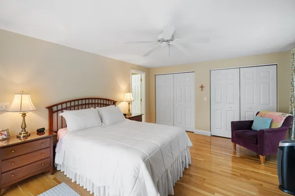 a bedroom with bed and wooden floor