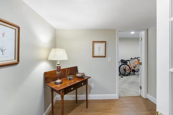 a room with furniture a lamp and a rug