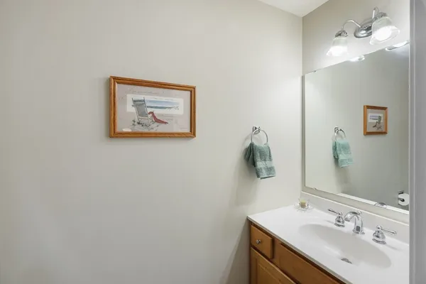 a bathroom with a sink vanity and a mirror