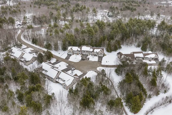 an aerial view of a house with outdoor space
