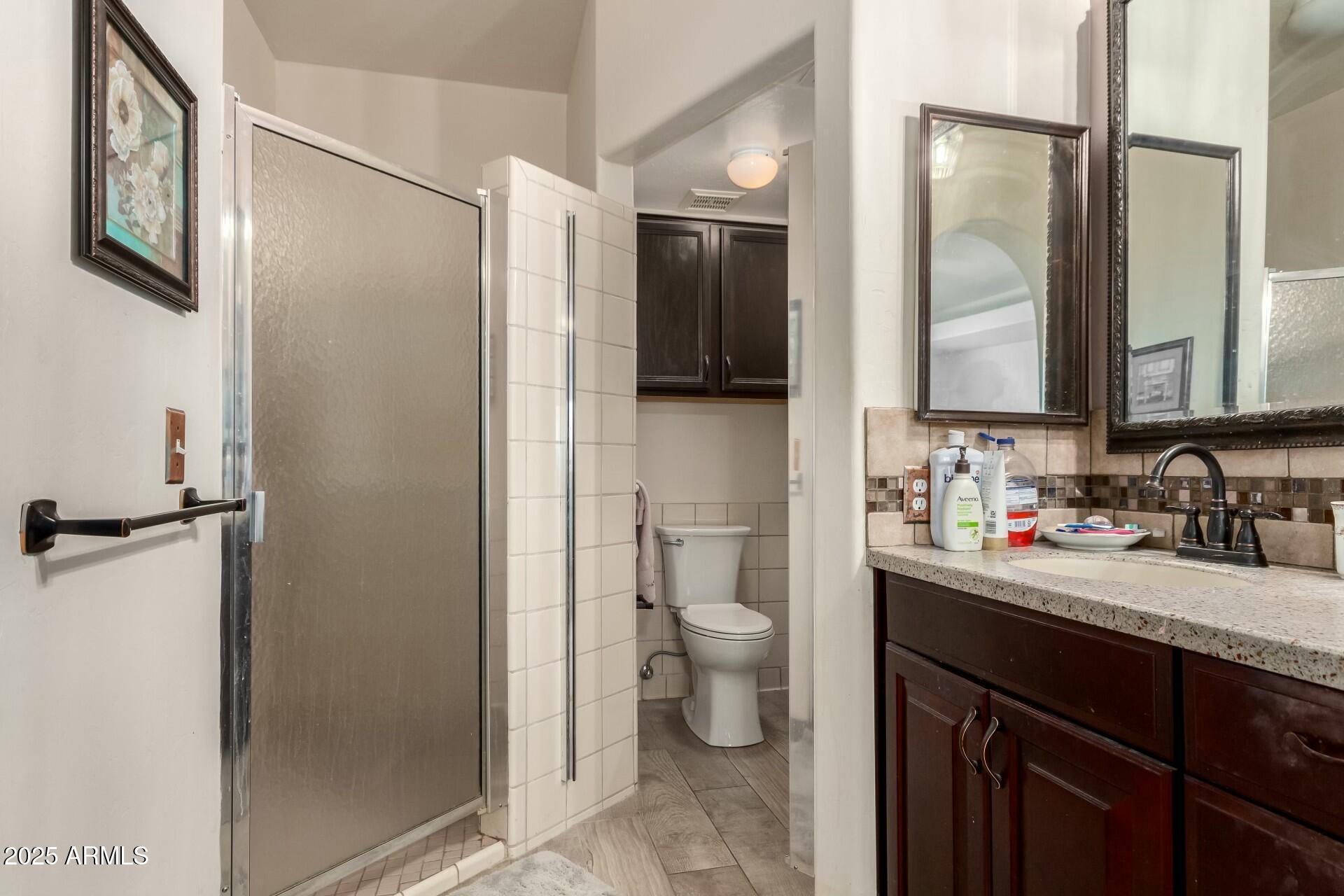 5445 East McKellips Road, Unit 54 Mesa, AZ 85215 - Photo 11 of 26 a bathroom with a granite countertop sink mirror vanity and toilet