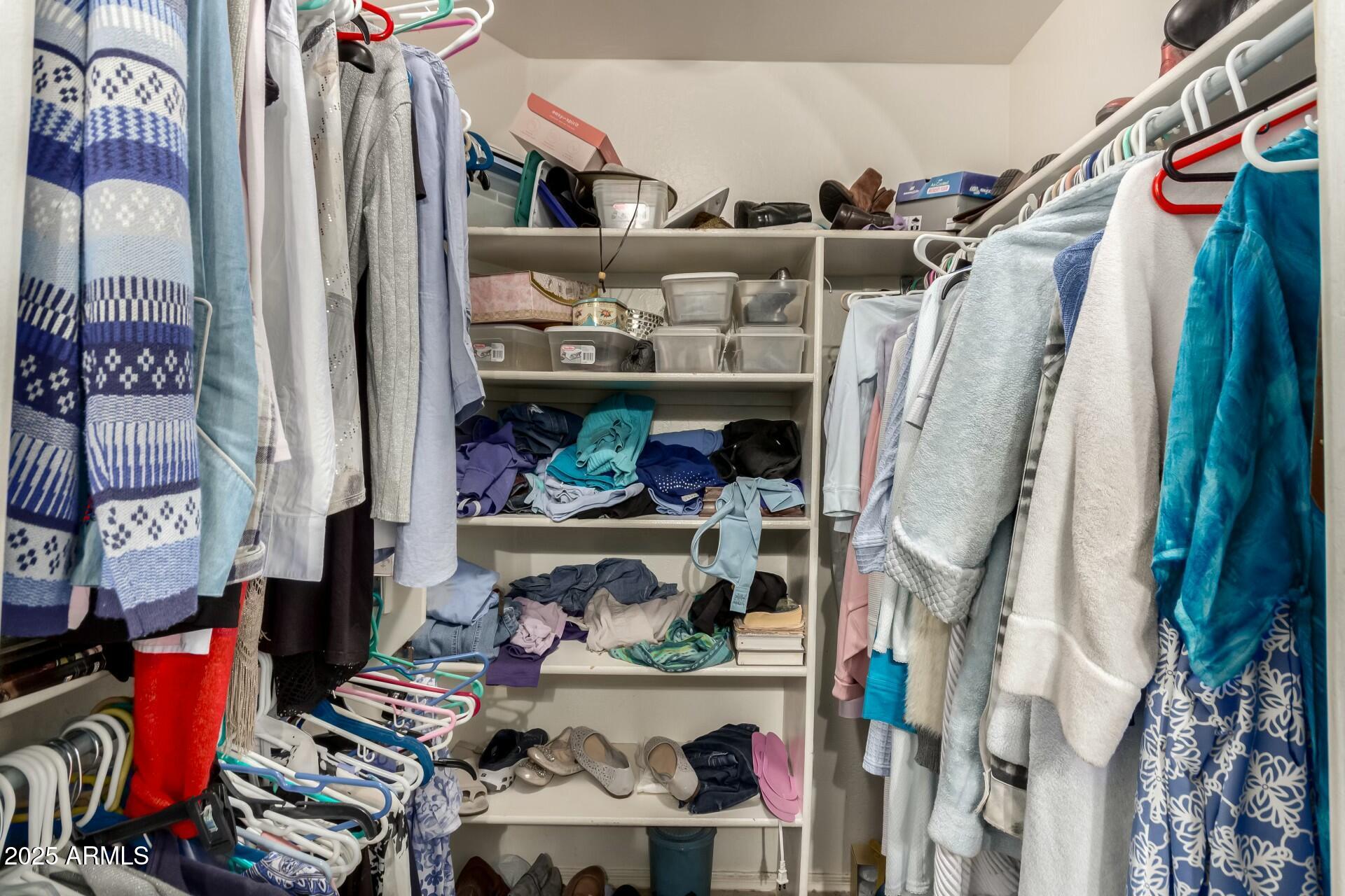 5445 East McKellips Road, Unit 54 Mesa, AZ 85215 - Photo 13 of 26 a view of walk in closet with clothes and shoes