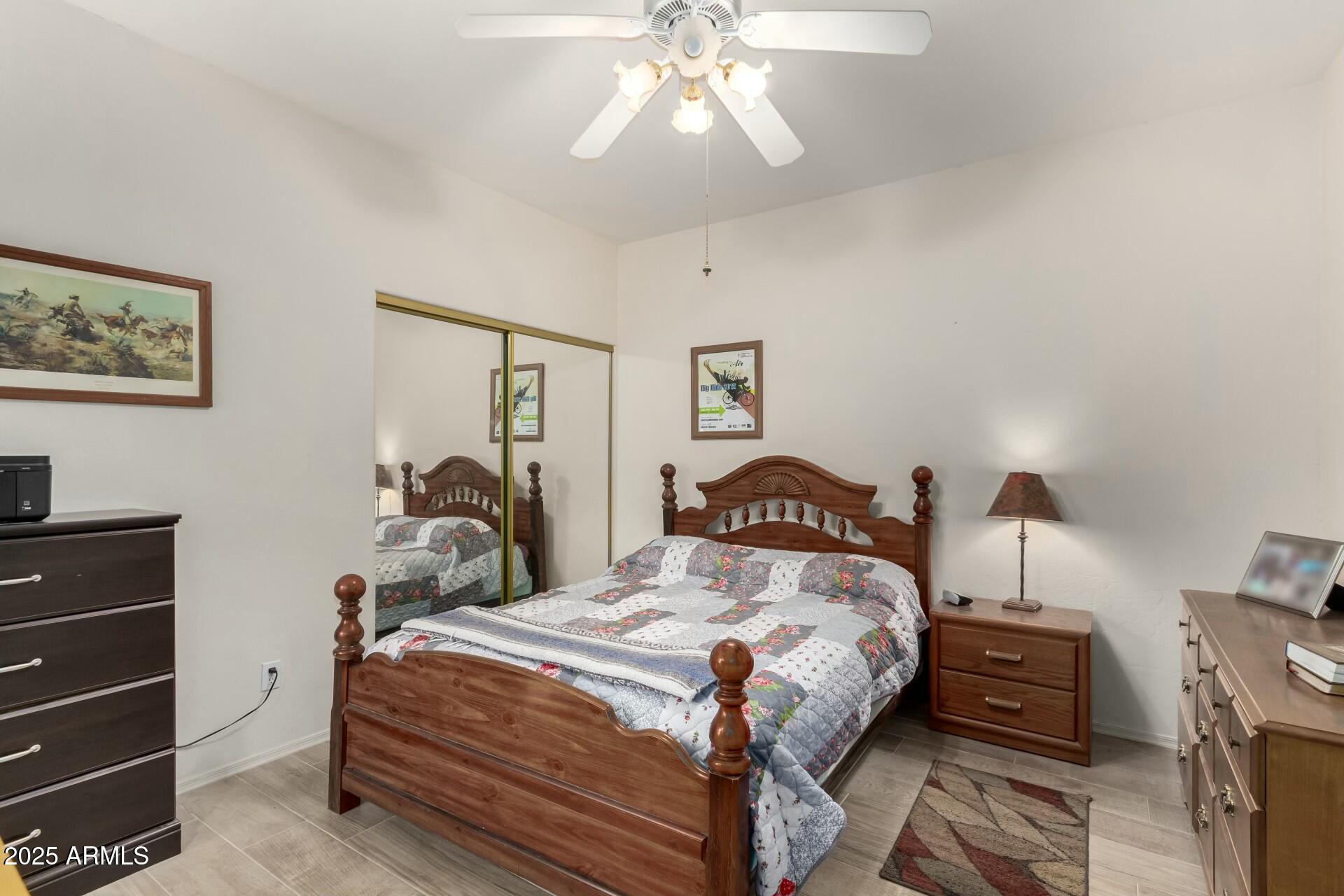 5445 East McKellips Road, Unit 54 Mesa, AZ 85215 - Photo 14 of 26 a bedroom with a bed and a chandelier