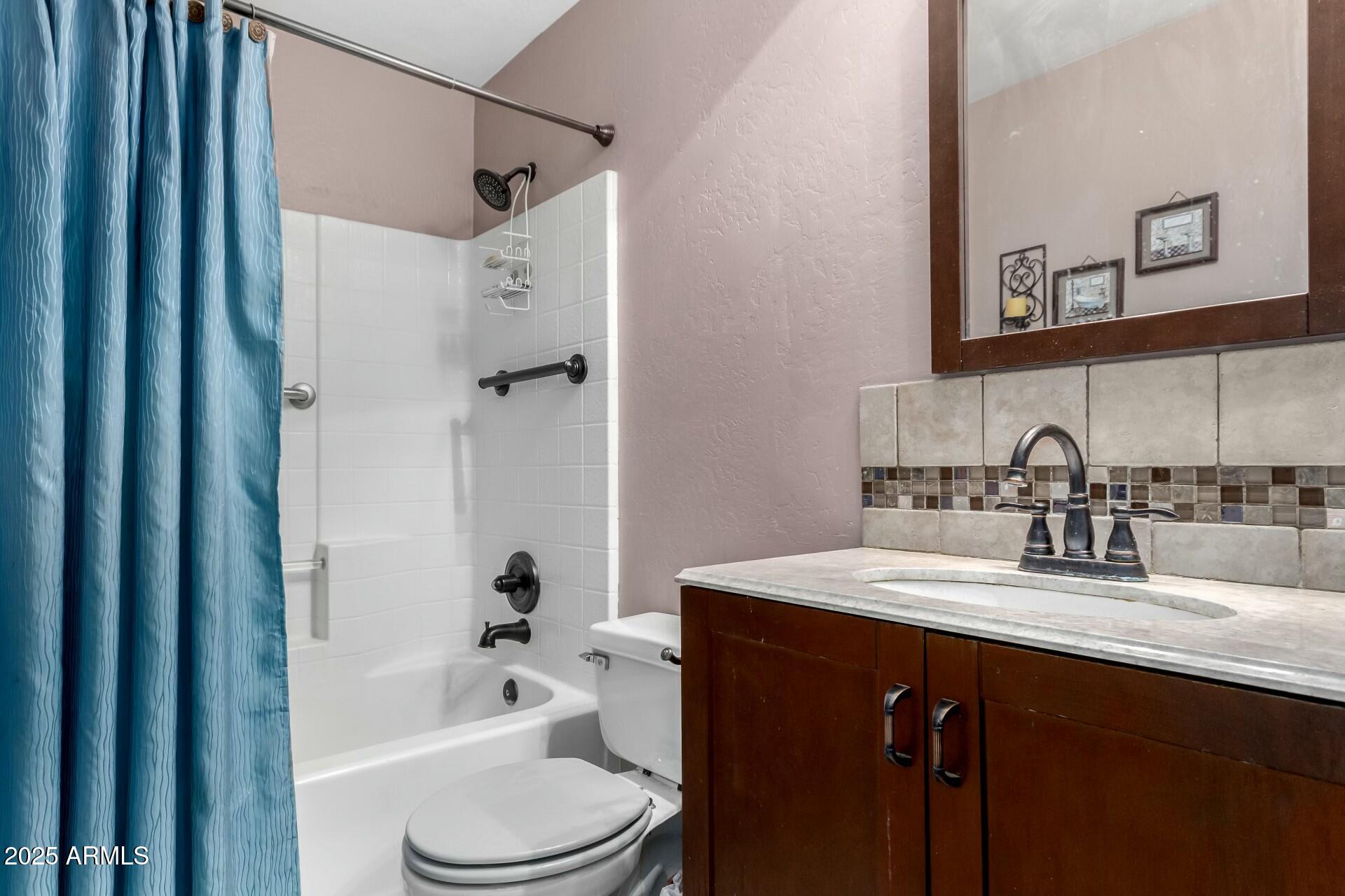 5445 East McKellips Road, Unit 54 Mesa, AZ 85215 - Photo 16 of 26 a bathroom with a granite countertop sink toilet and shower