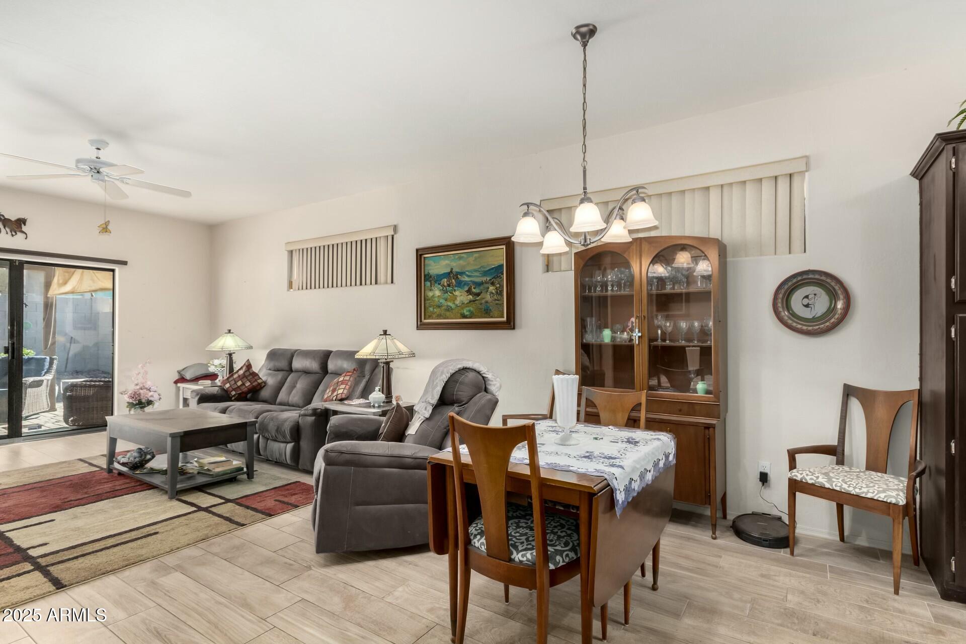 5445 East McKellips Road, Unit 54 Mesa, AZ 85215 - Photo 6 of 26 a living room with furniture a clock and a window