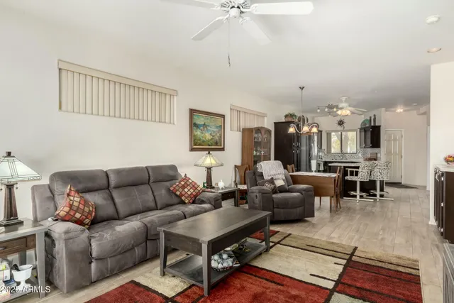 a living room with furniture a rug and a chandelier