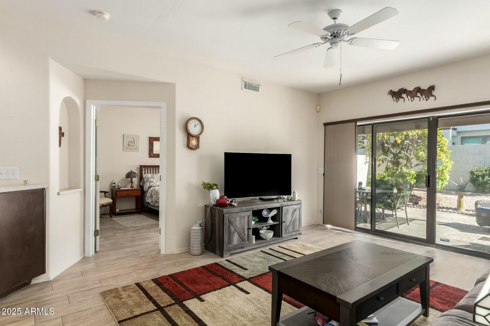 5445 East McKellips Road, Unit 54 Mesa, AZ 85215 - Photo 8 of 26 a living room with furniture and a flat screen tv