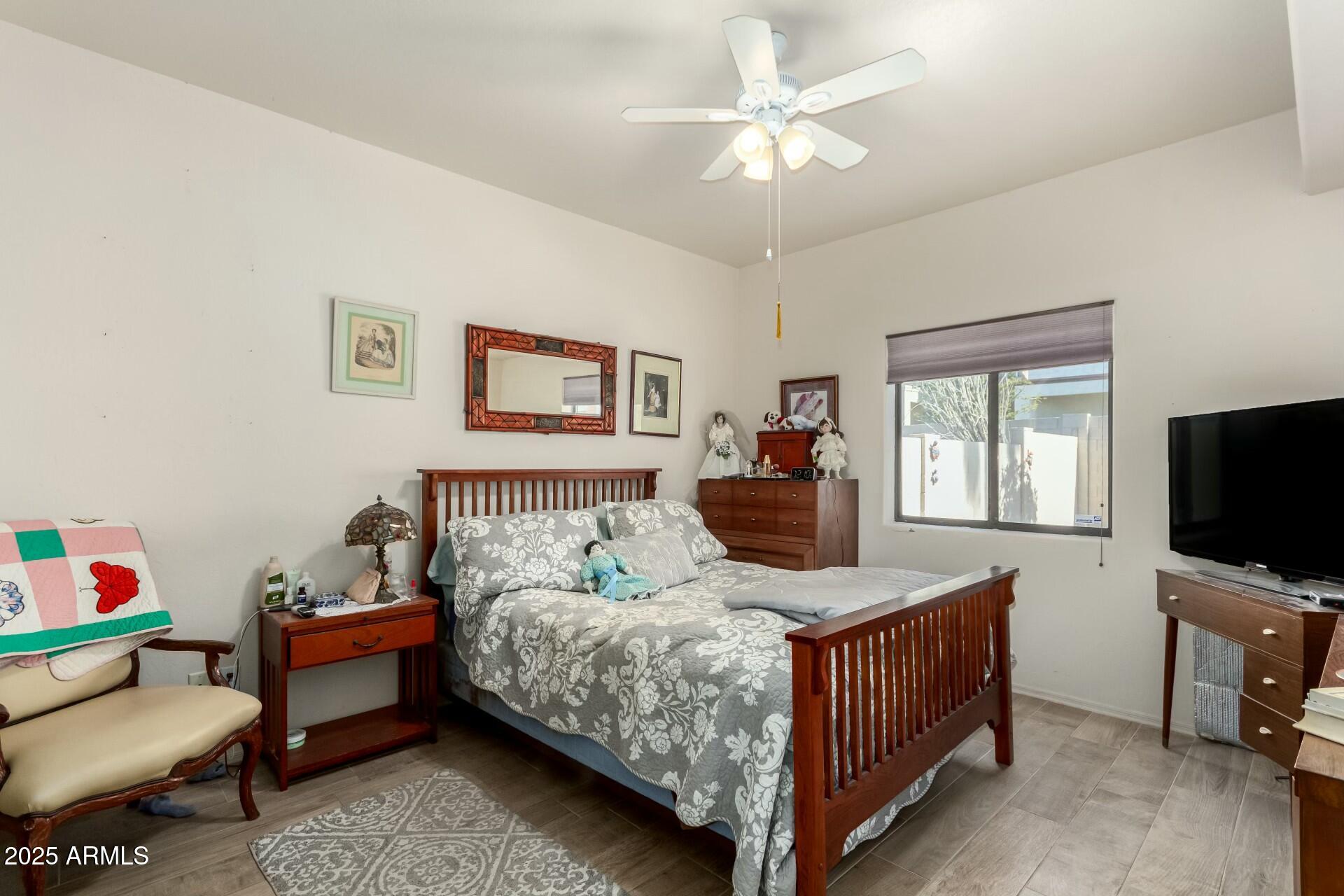 5445 East McKellips Road, Unit 54 Mesa, AZ 85215 - Photo 9 of 26 a bedroom with a bed and a flat screen tv