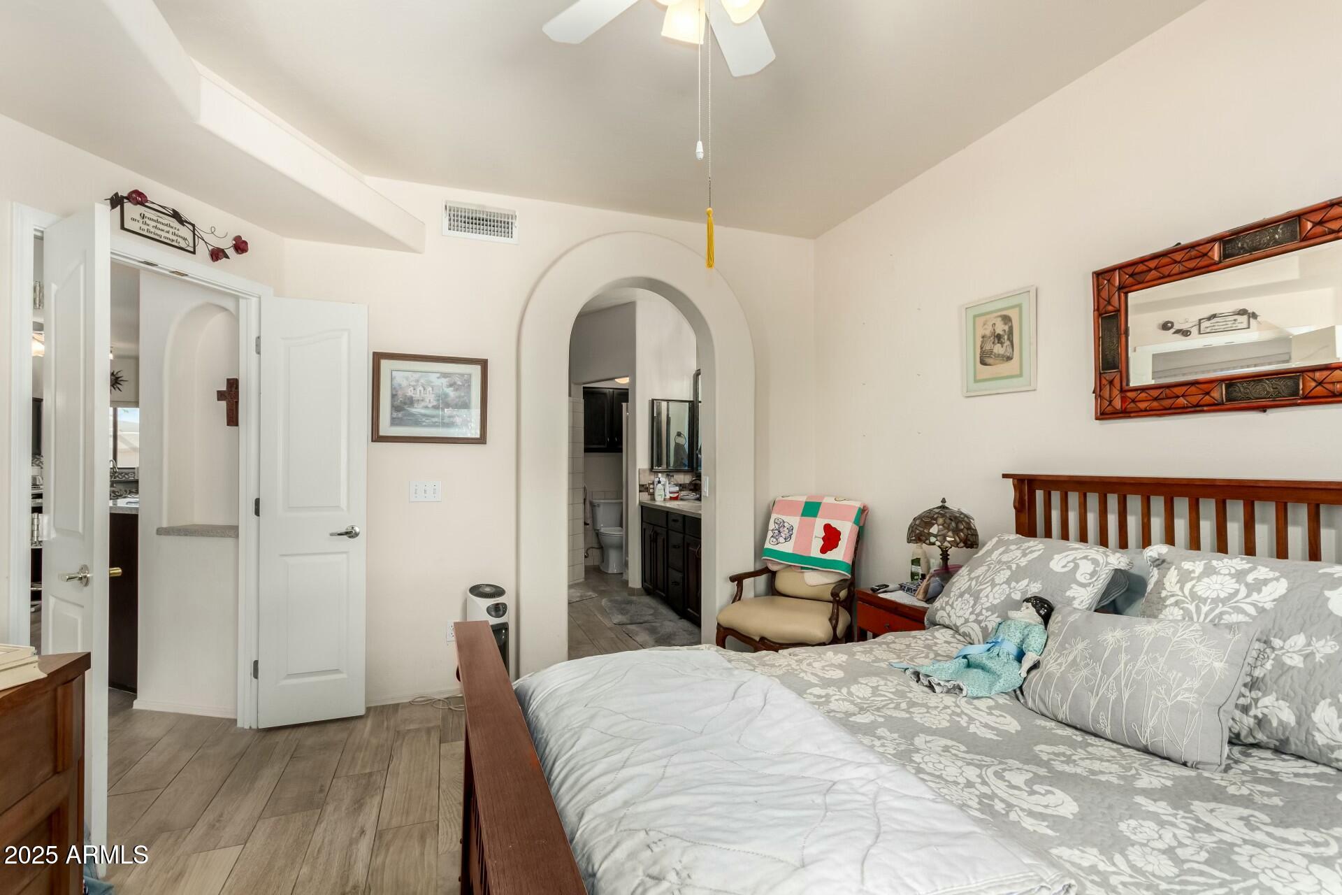 5445 East McKellips Road, Unit 54 Mesa, AZ 85215 - Photo 10 of 26 a bedroom with bed and wooden floor