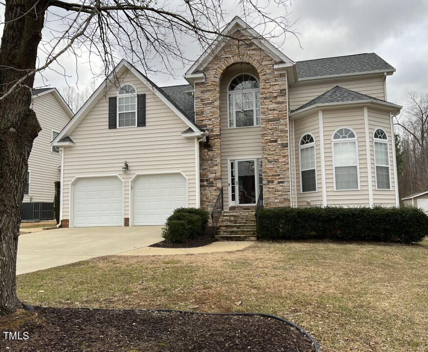 613 Seastone Street Raleigh, NC 27603 - Photo 1 of 13 a front view of a house with a yard