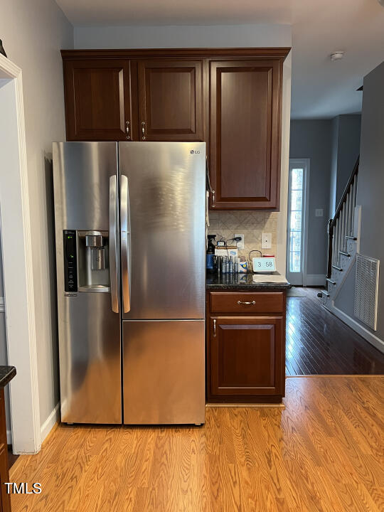 613 Seastone Street Raleigh, NC 27603 - Photo 12 of 13 a kitchen with stainless steel appliances granite countertop a refrigerator and a stove