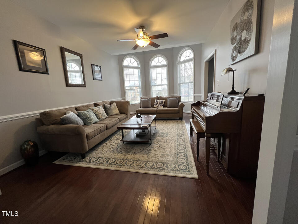 613 Seastone Street Raleigh, NC 27603 - Photo 9 of 13 a living room with furniture and wooden floor