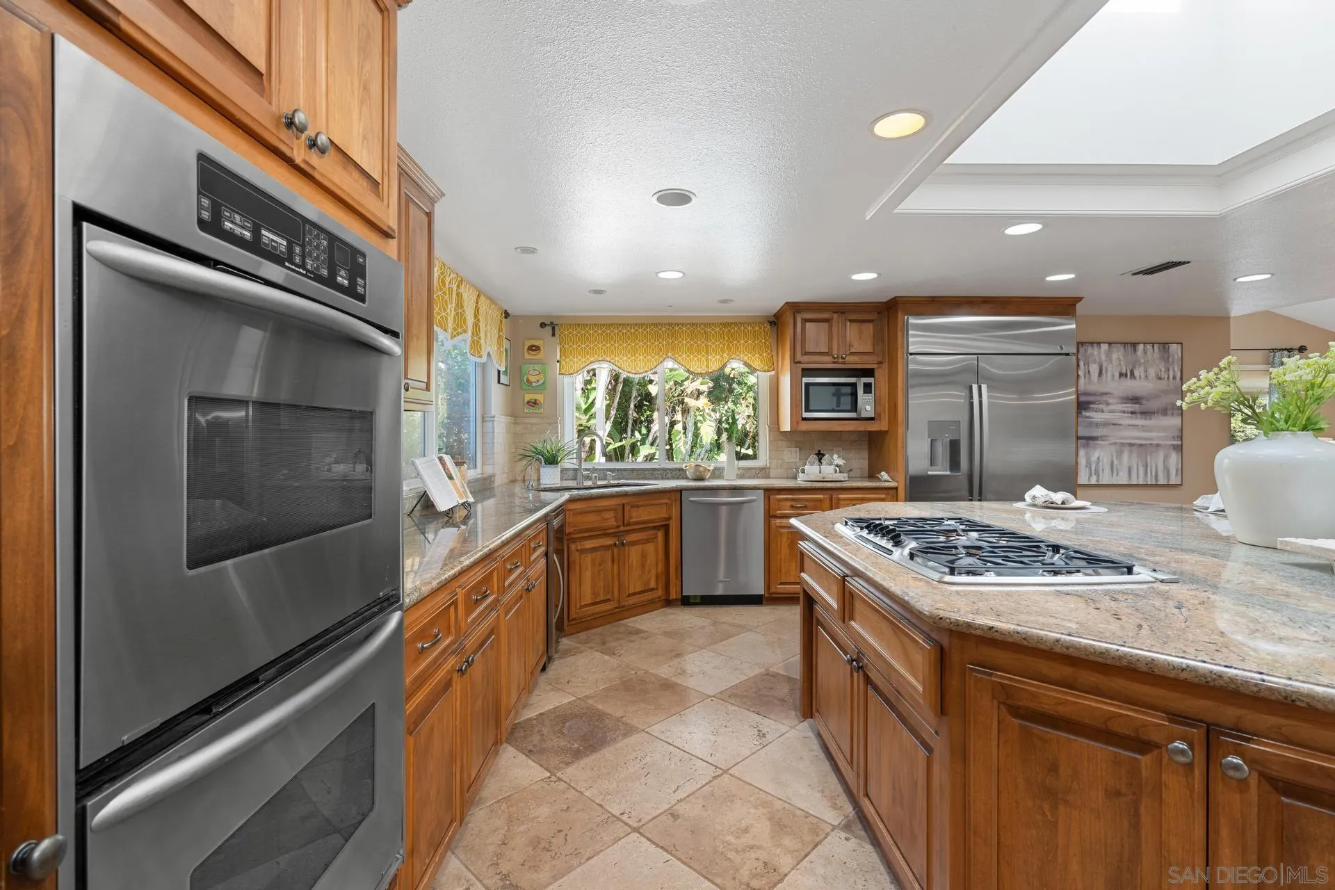 13678 Orchard Gate Road Poway, CA 92064 - Photo 9 of 29 a kitchen with stainless steel appliances granite countertop a stove a sink and a refrigerator