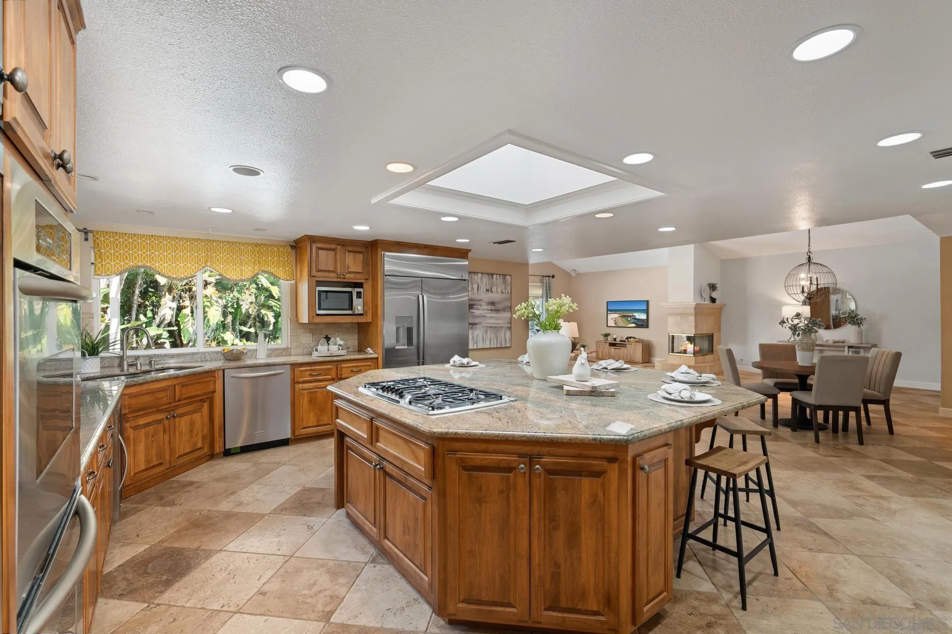 13678 Orchard Gate Road Poway, CA 92064 - Photo 10 of 29 a kitchen with stainless steel appliances granite countertop a stove a sink a oven a dining table and chairs