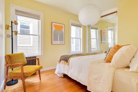 a bedroom with a bed and window